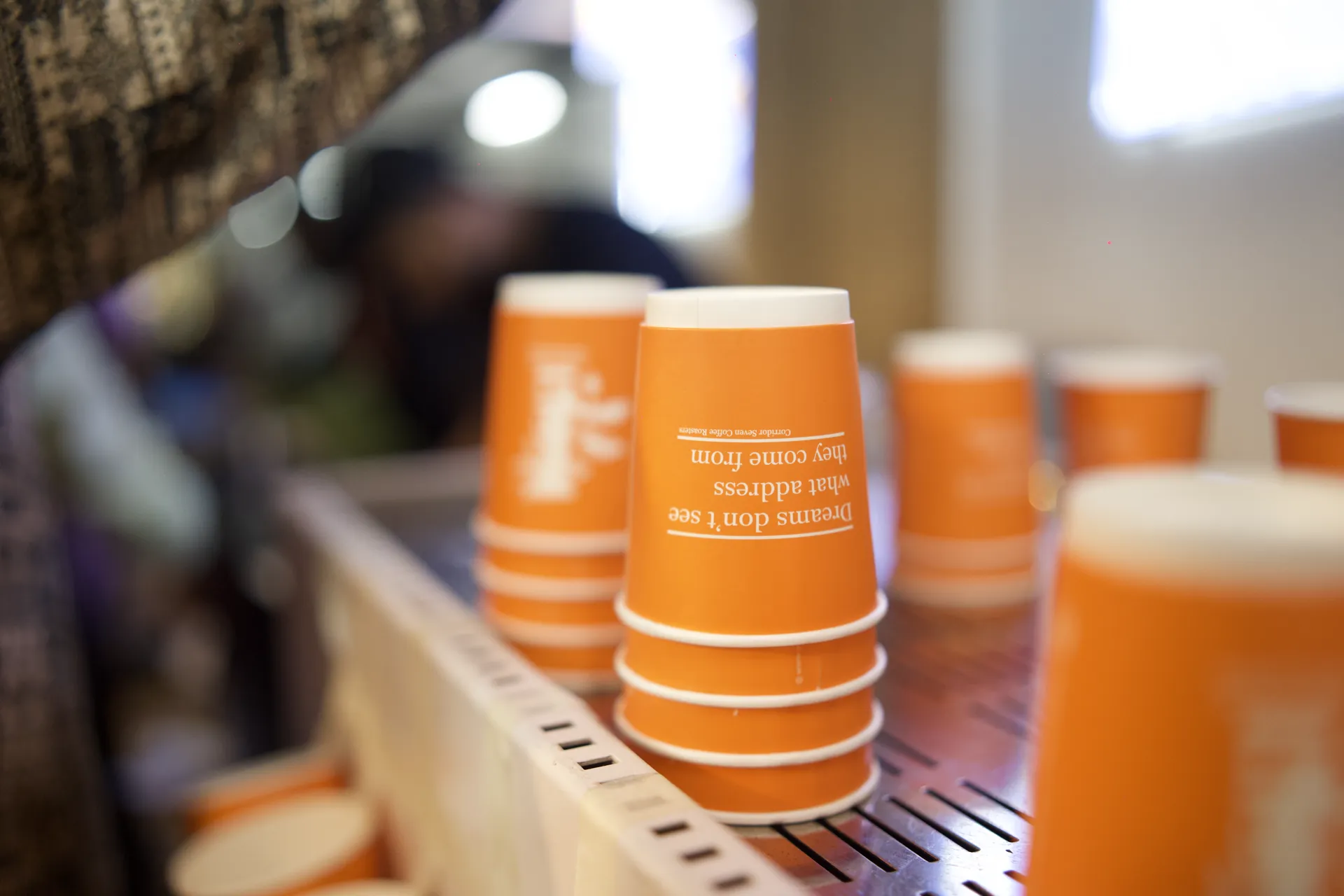Stacked cups at the coffee vendor stall on the Dholida grounds